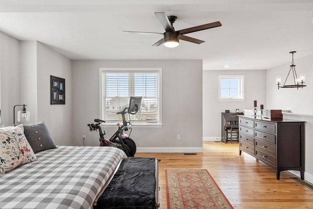 57 Railroad Ave Unit C1, Salisbury, MA 01952 - bedroom with light wood finished floors, a chandelier, and ceiling fan