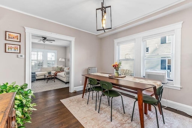 dining room featuring baseboards, ceiling fan, ornamental molding, dark wood-type flooring, and cooling unit