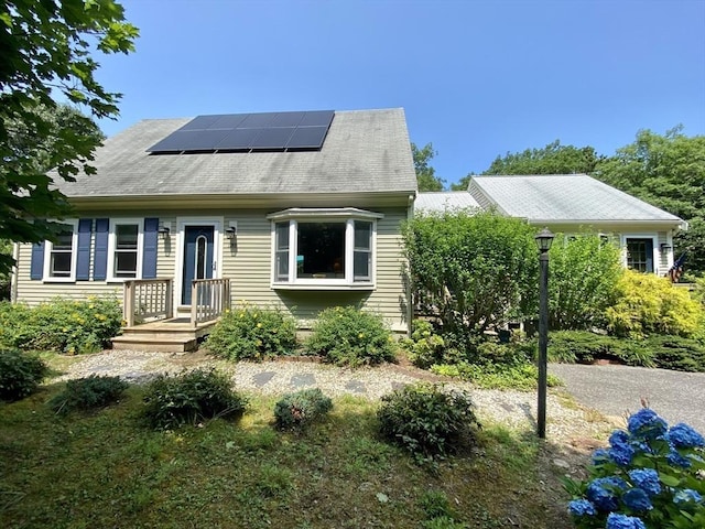 view of front of property featuring solar panels