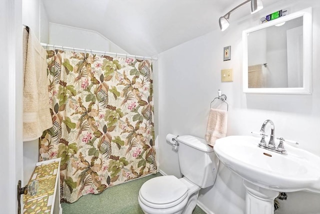 bathroom with lofted ceiling, sink, and toilet