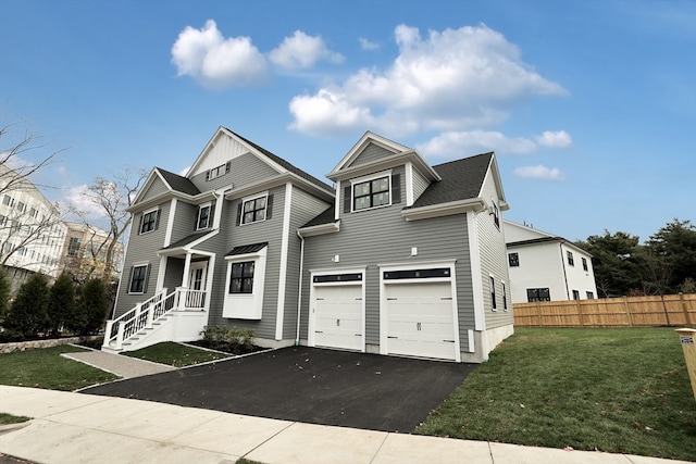 view of front of property with a front yard and a garage