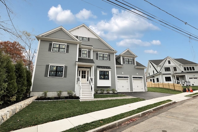 view of front of house with a front yard and a garage