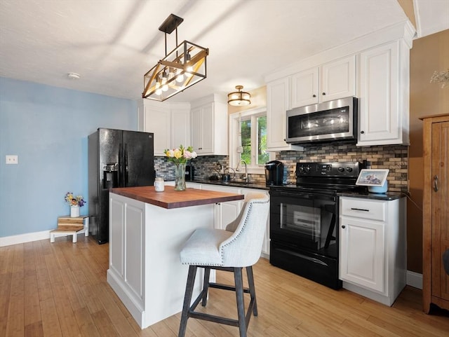 11 Grove Point Rd, Wales, MA 01081 - kitchen featuring black appliances, wooden counters, white cabinetry, tasteful backsplash, and light wood-style floors