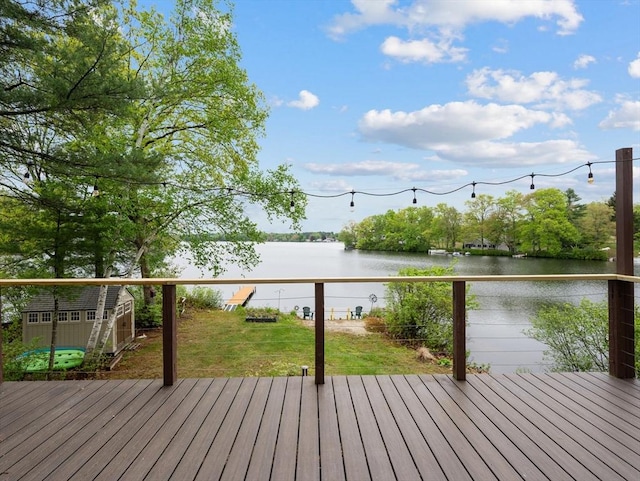 11 Grove Point Rd, Wales, MA 01081 - wooden terrace with a water view, a storage unit, an outdoor structure, and a yard