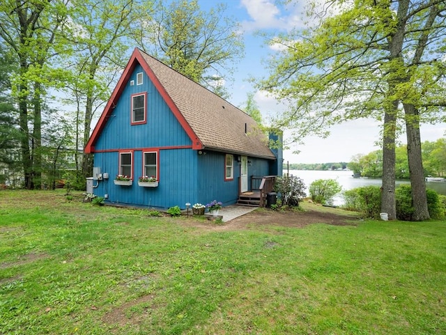 11 Grove Point Rd, Wales, MA 01081 - view of property exterior with a water view, roof with shingles, and a lawn