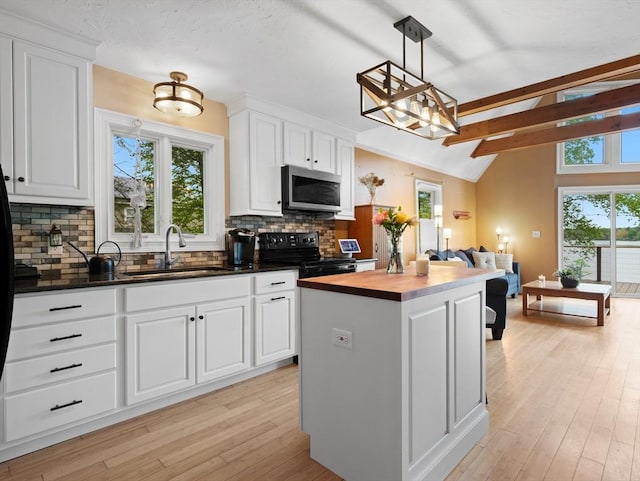 11 Grove Point Rd, Wales, MA 01081 - kitchen with stainless steel microwave, black electric range oven, a sink, open floor plan, and decorative backsplash