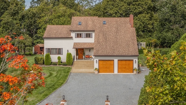 view of front facade with a garage and a front yard