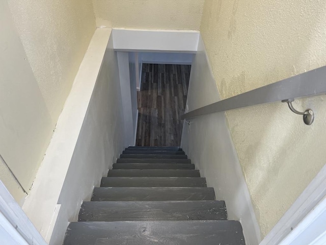 staircase with a textured wall