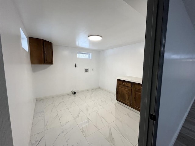 clothes washing area with hookup for an electric dryer, washer hookup, baseboards, marble finish floor, and cabinet space