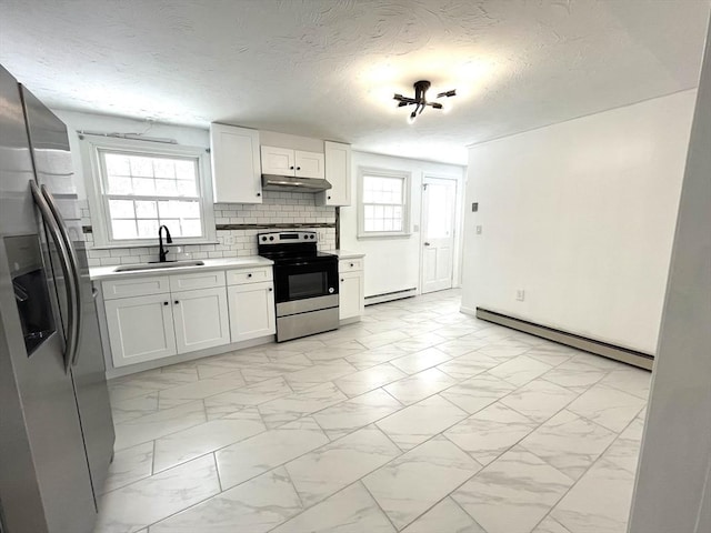 kitchen featuring a baseboard radiator, marble finish floor, stainless steel appliances, light countertops, and a sink