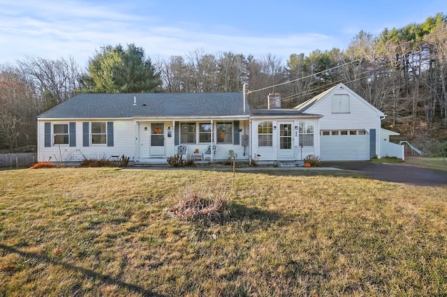 ranch-style house with a garage and a front lawn