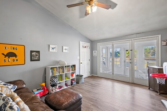 living room with vaulted ceiling, light hardwood / wood-style flooring, and ceiling fan