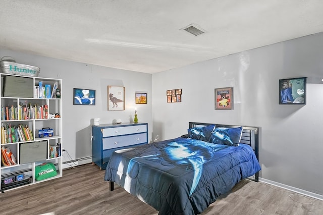 bedroom with wood-type flooring