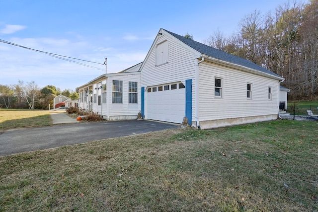 view of side of property with a lawn and a garage