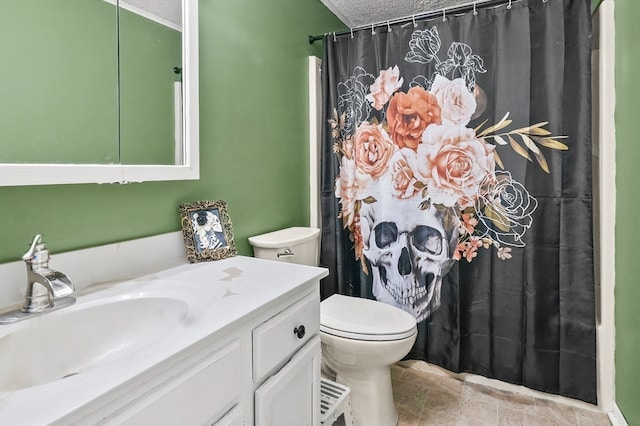 bathroom featuring tile patterned flooring, vanity, a textured ceiling, and toilet