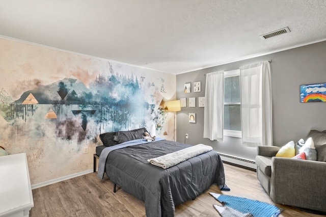 bedroom featuring a textured ceiling, crown molding, light wood-type flooring, and baseboard heating