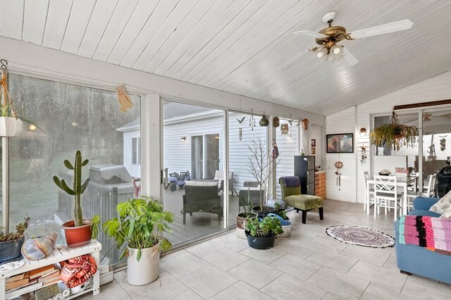 sunroom featuring ceiling fan, plenty of natural light, wood ceiling, and lofted ceiling