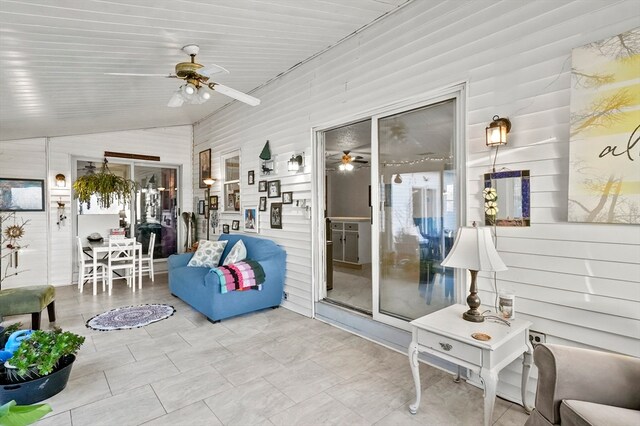 sunroom / solarium featuring vaulted ceiling