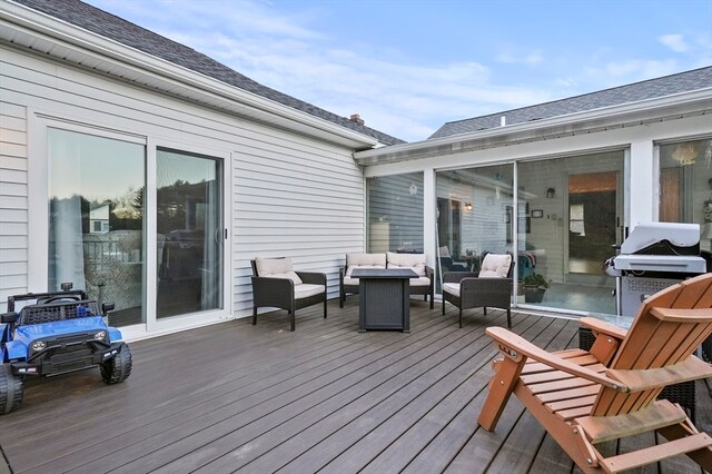 wooden terrace with outdoor lounge area and a grill