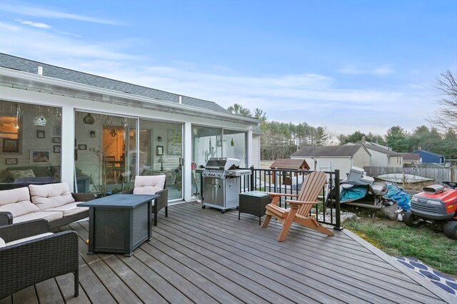 wooden deck featuring area for grilling and an outdoor hangout area