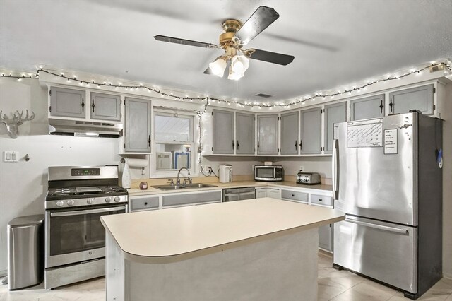 kitchen featuring sink, ceiling fan, light tile patterned floors, appliances with stainless steel finishes, and a kitchen island