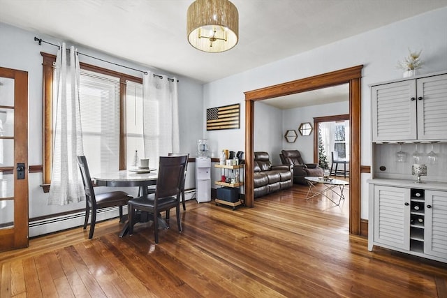 dining space featuring dark hardwood / wood-style floors and baseboard heating