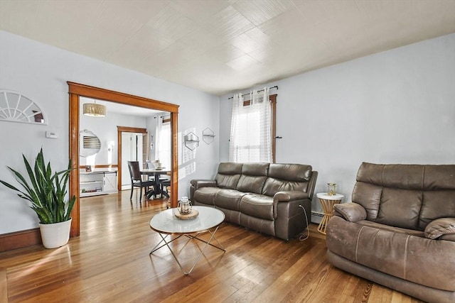 living room featuring hardwood / wood-style flooring and a baseboard heating unit