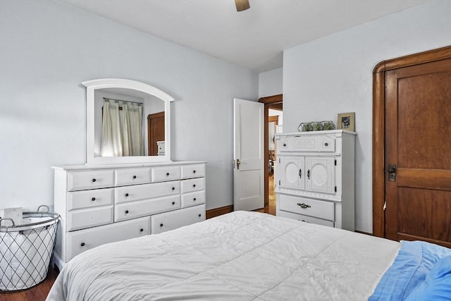 bedroom with ceiling fan and dark wood-type flooring