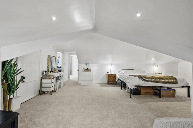 carpeted bedroom with lofted ceiling