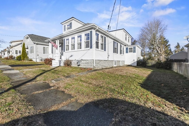 view of side of home with a yard