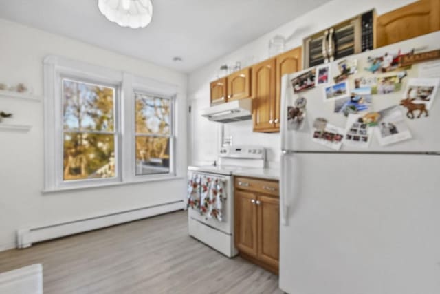 kitchen featuring white appliances, light hardwood / wood-style flooring, and a baseboard heating unit