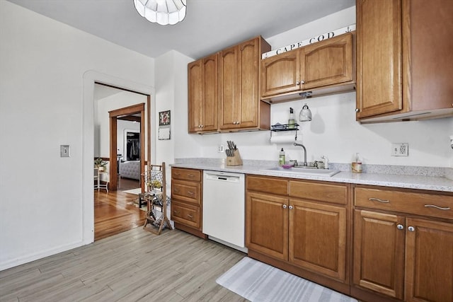 kitchen with dishwasher, light wood-type flooring, and sink