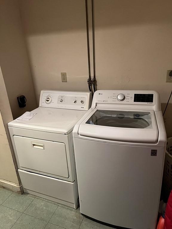 clothes washing area featuring washer and clothes dryer