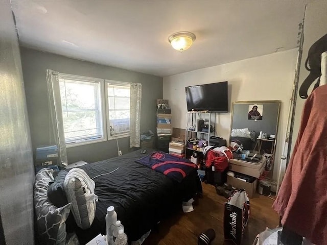 bedroom with dark wood-type flooring