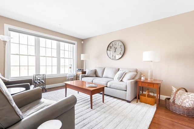 living room featuring baseboards and wood finished floors