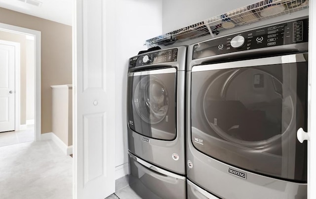 laundry room with light tile patterned floors, laundry area, and independent washer and dryer