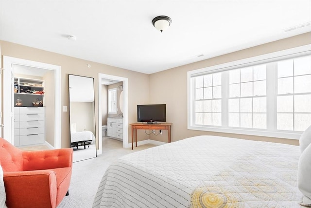 bedroom with baseboards, visible vents, and light carpet