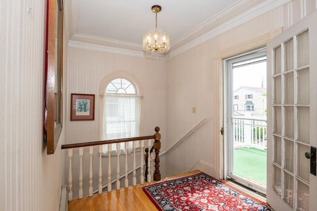 27 Stephen St, Lynn, MA 01902 - doorway with ornamental molding, a chandelier, and wood finished floors