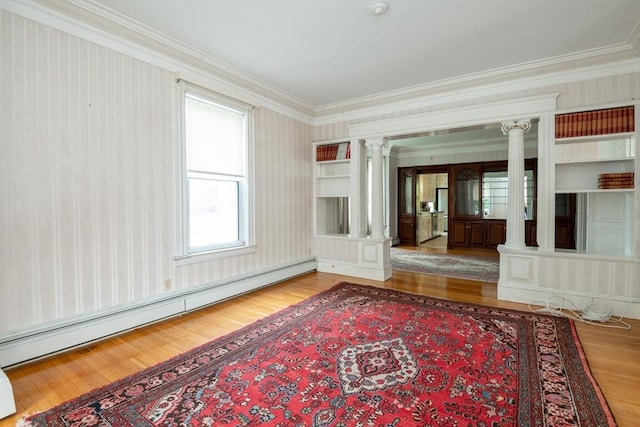 27 Stephen St, Lynn, MA 01902 - unfurnished living room with decorative columns, a baseboard heating unit, ornamental molding, wood finished floors, and wallpapered walls