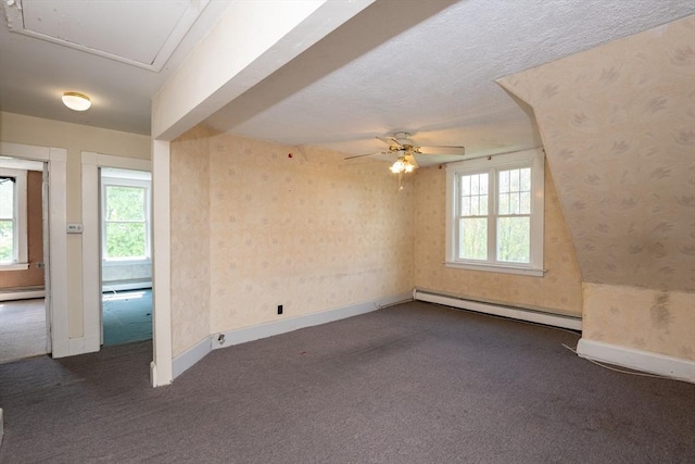 27 Stephen St, Lynn, MA 01902 - empty room featuring baseboard heating, dark colored carpet, a ceiling fan, and baseboards