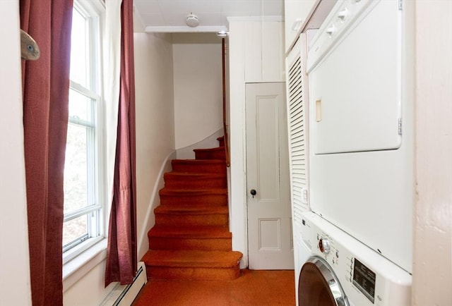 27 Stephen St, Lynn, MA 01902 - laundry room with stacked washer and clothes dryer, a baseboard heating unit, ornamental molding, and light carpet