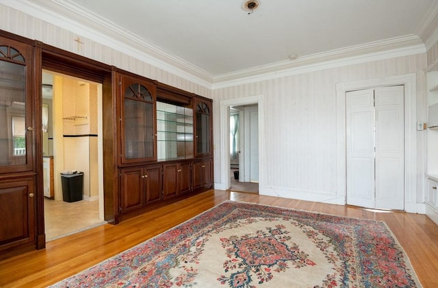 27 Stephen St, Lynn, MA 01902 - empty room featuring light wood-style floors, crown molding, wallpapered walls, baseboards, and fire sprinkler in ceiling