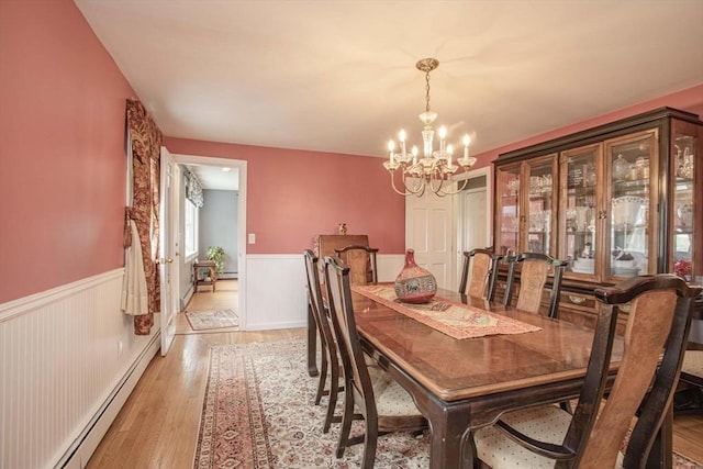 374 Forest St, Raynham, MA 02767 - dining space featuring a wainscoted wall, a chandelier, light wood-style floors, a baseboard radiator, and baseboard heating