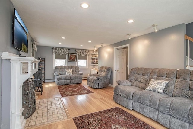 374 Forest St, Raynham, MA 02767 - living area featuring wood finished floors, recessed lighting, baseboard heating, and a fireplace with flush hearth
