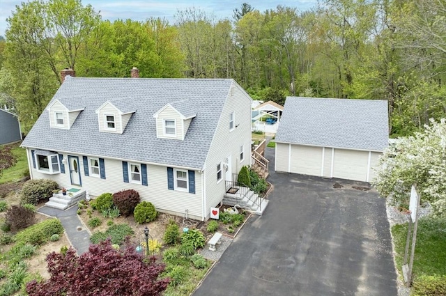 374 Forest St, Raynham, MA 02767 - cape cod home with an outbuilding, a chimney, a detached garage, and roof with shingles