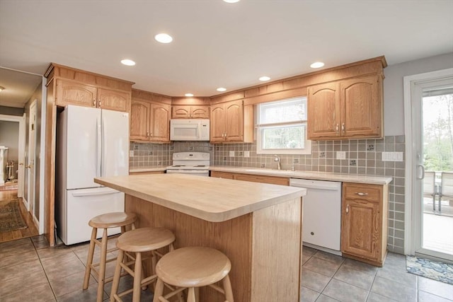 374 Forest St, Raynham, MA 02767 - kitchen featuring white appliances, a sink, light countertops, light tile patterned flooring, and recessed lighting