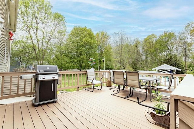 374 Forest St, Raynham, MA 02767 - wooden terrace featuring area for grilling, outdoor dining area, and view of scattered trees