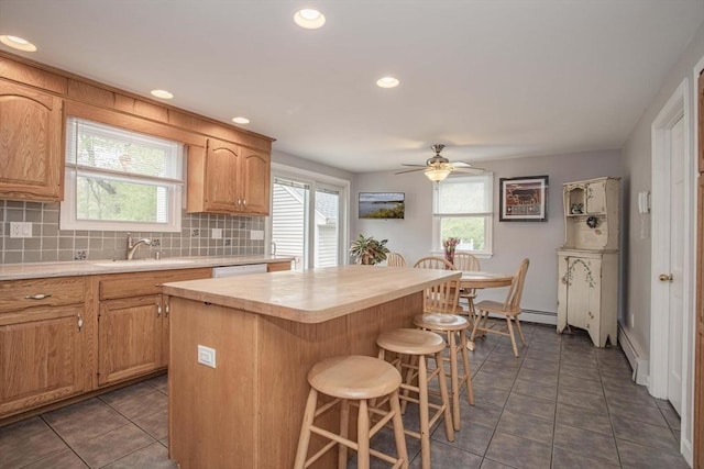 374 Forest St, Raynham, MA 02767 - kitchen featuring light countertops, a sink, a kitchen breakfast bar, tile patterned flooring, and recessed lighting