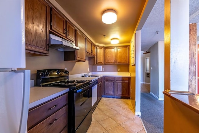 kitchen featuring light tile patterned flooring, white refrigerator, black range with electric stovetop, and sink