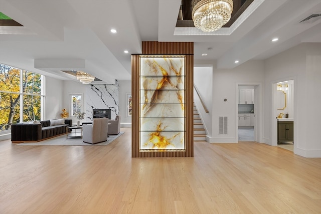 interior space featuring hardwood / wood-style floors, a fireplace, and an inviting chandelier